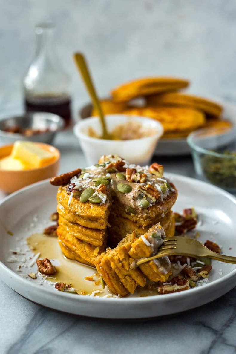 healthy pumpkin protein pancakes topped with pepitas