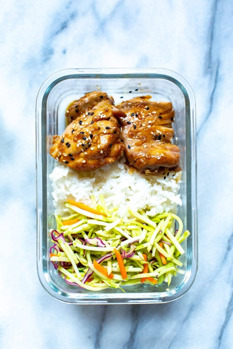 meal prep dinner of Garlic Sesame Chicken Thighs, white rice, and broccoli slaw