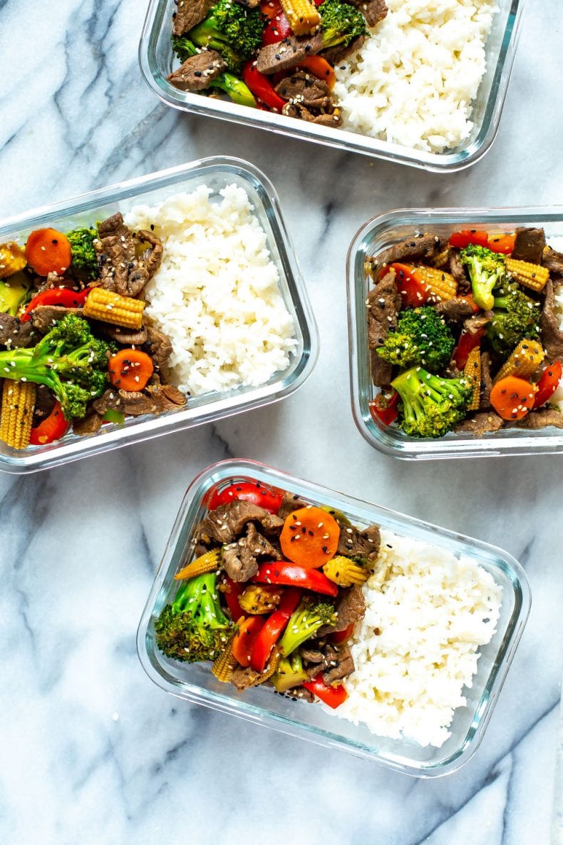Broccoli, baby corn, red bell peppers and str fried beef in glass meal prep containers