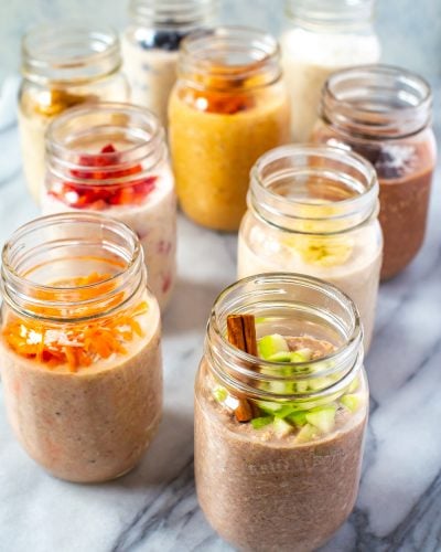 9 mason jars, each with filled with a different flavour of overnight oats.