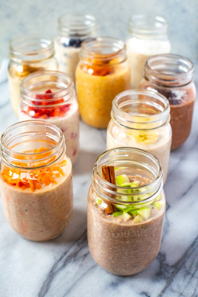 9 mason jars, each with filled with a different flavour of overnight oats.