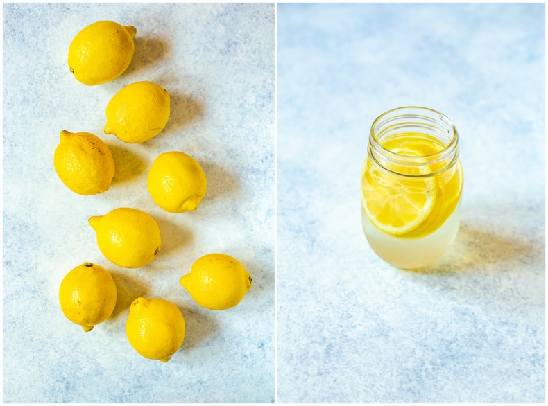 fresh lemons and a glass of water with sliced lemons