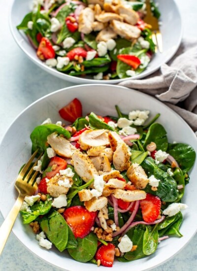 2 bowls of strawberry spinach salad with chicken