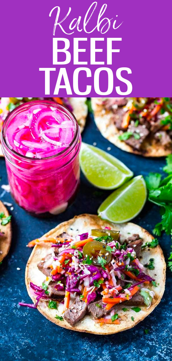 These Kalbi Beef Tacos are inspired by Korean cuisine with a delicious kalbi marinade and pickled red onions topped with citrus slaw! #kalbibeef #tacos