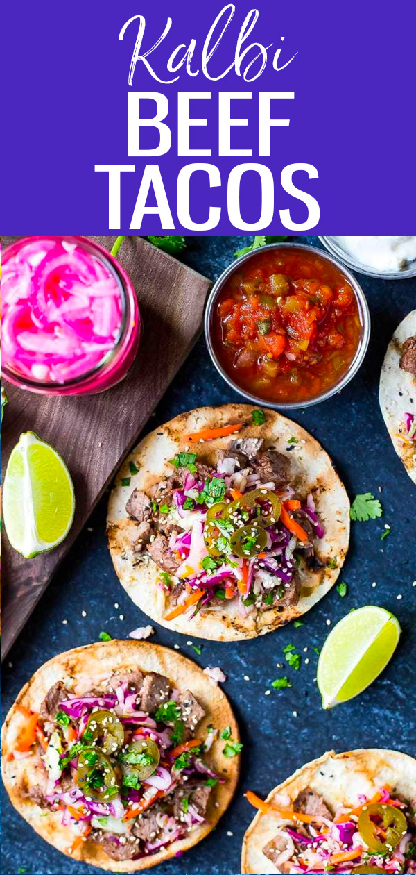 These Kalbi Beef Tacos are inspired by Korean cuisine with a delicious kalbi marinade and pickled red onions topped with citrus slaw! #kalbibeef #tacos