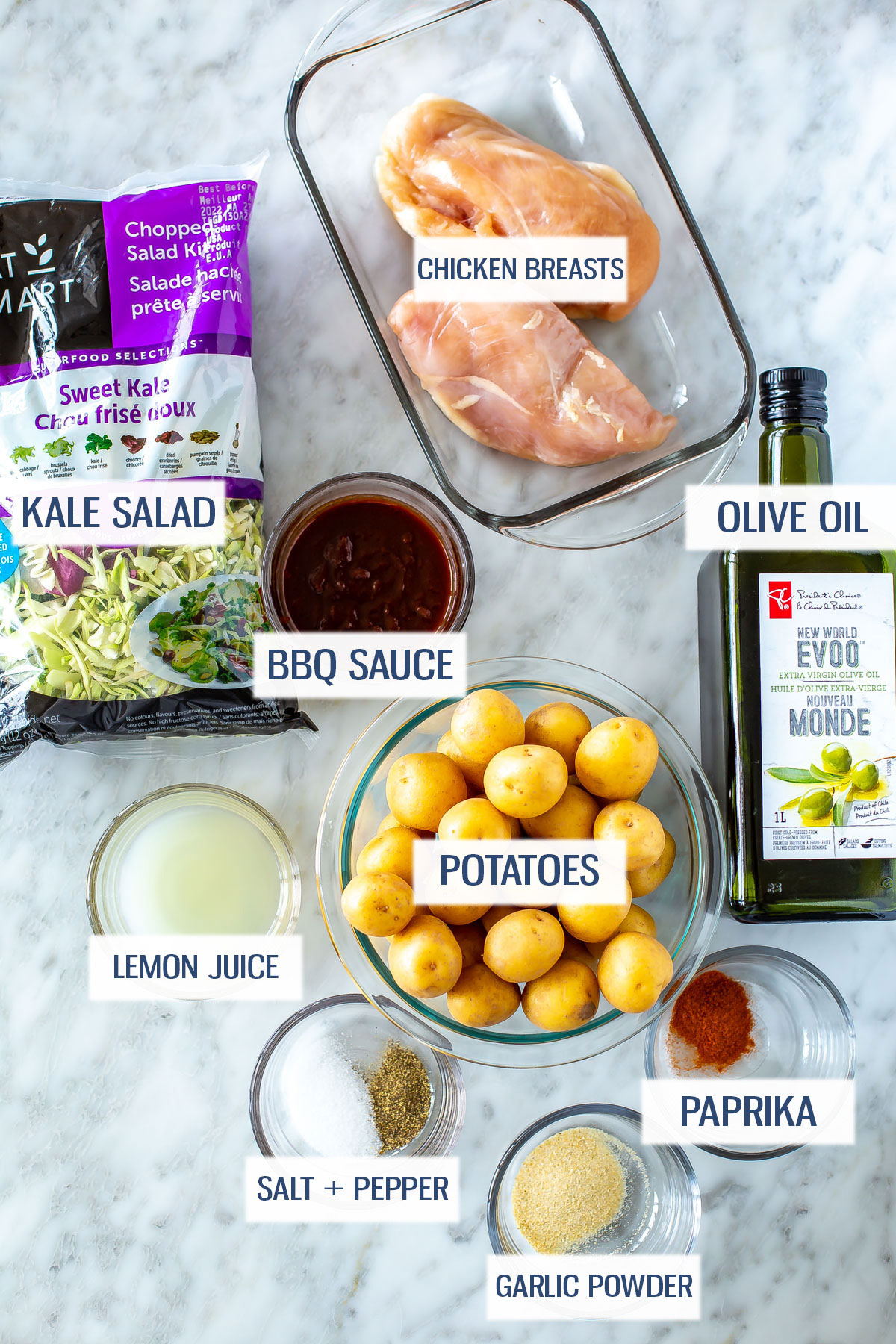 Ingredients for baked BBQ chicken meal prep: chicken breasts, kale salad, bbq sauce, olive oil, lemon juice, baby potatoes, paprika, garlic powder, and salt and pepper.