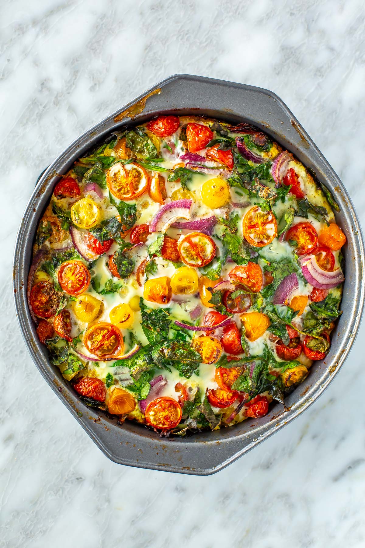 A baked egg white frittata in a pan.