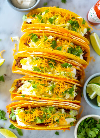 An overhead shot of five cheesy gordita crunch tacos.