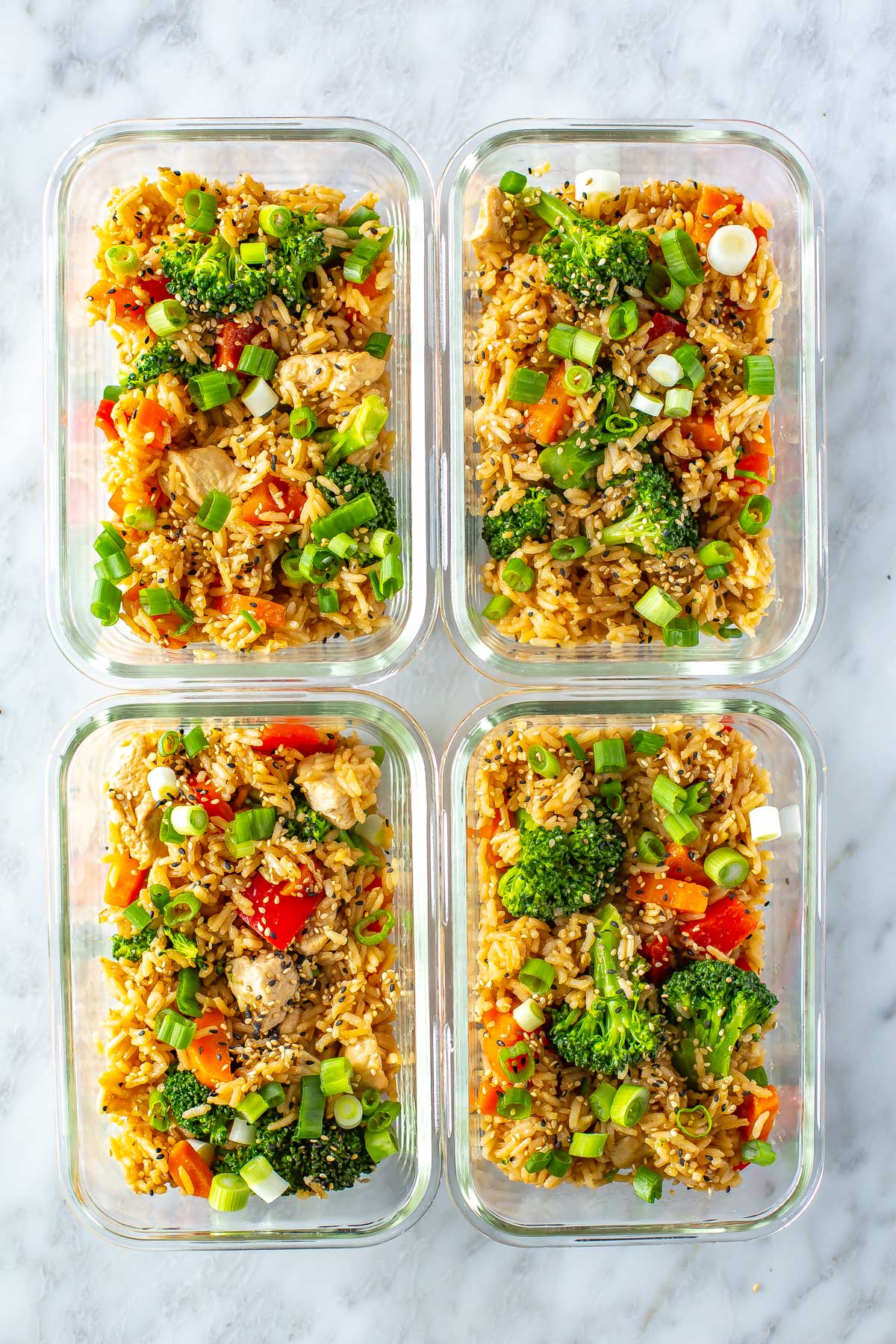 Four meal prep containers, each with a serving of Instant Pot teriyaki chicken.
