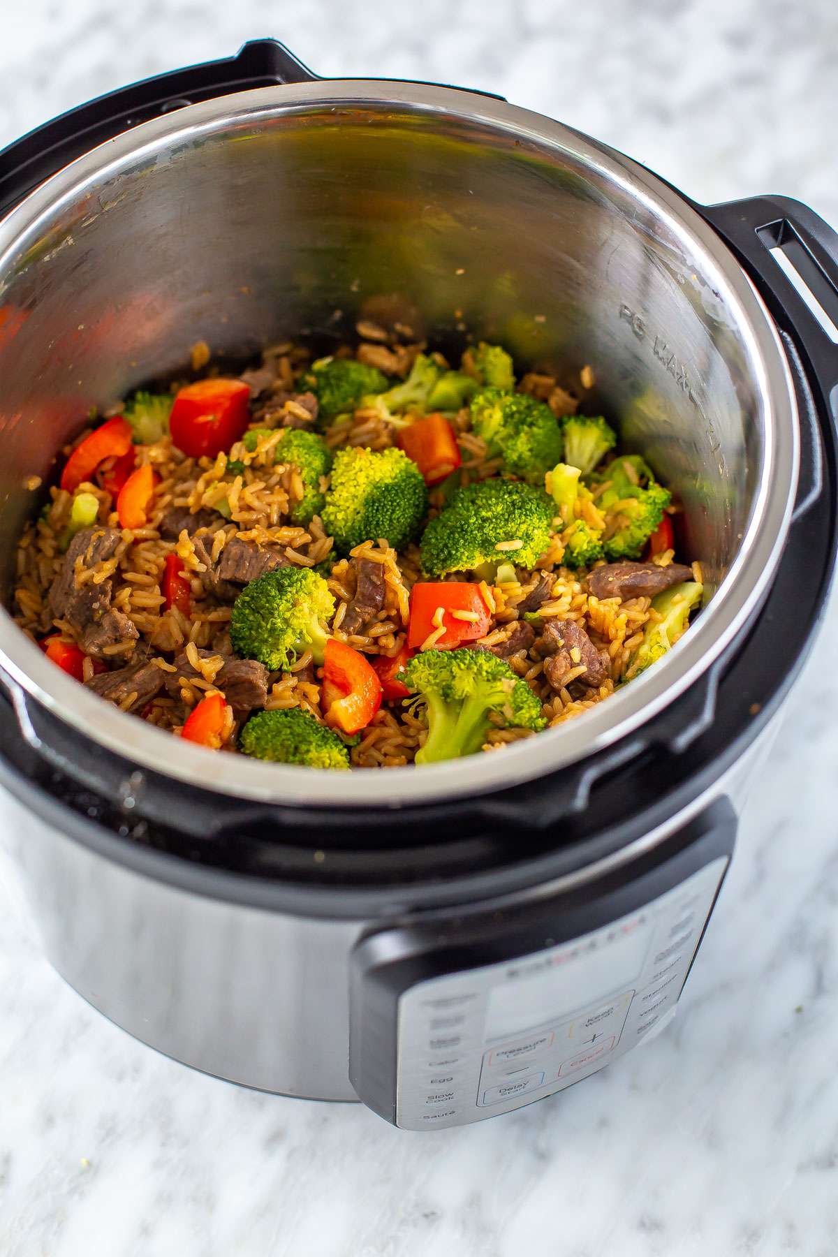 An overhead shot of an Instant Pot with beef and broccoli inside.