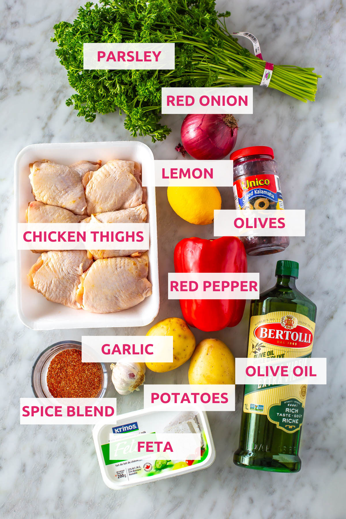 Ingredients for baked chicken thighs: chicken thighs, spice blend, olive oil, lemon, garlic, feta, red pepper, olives, red onion and parsley.