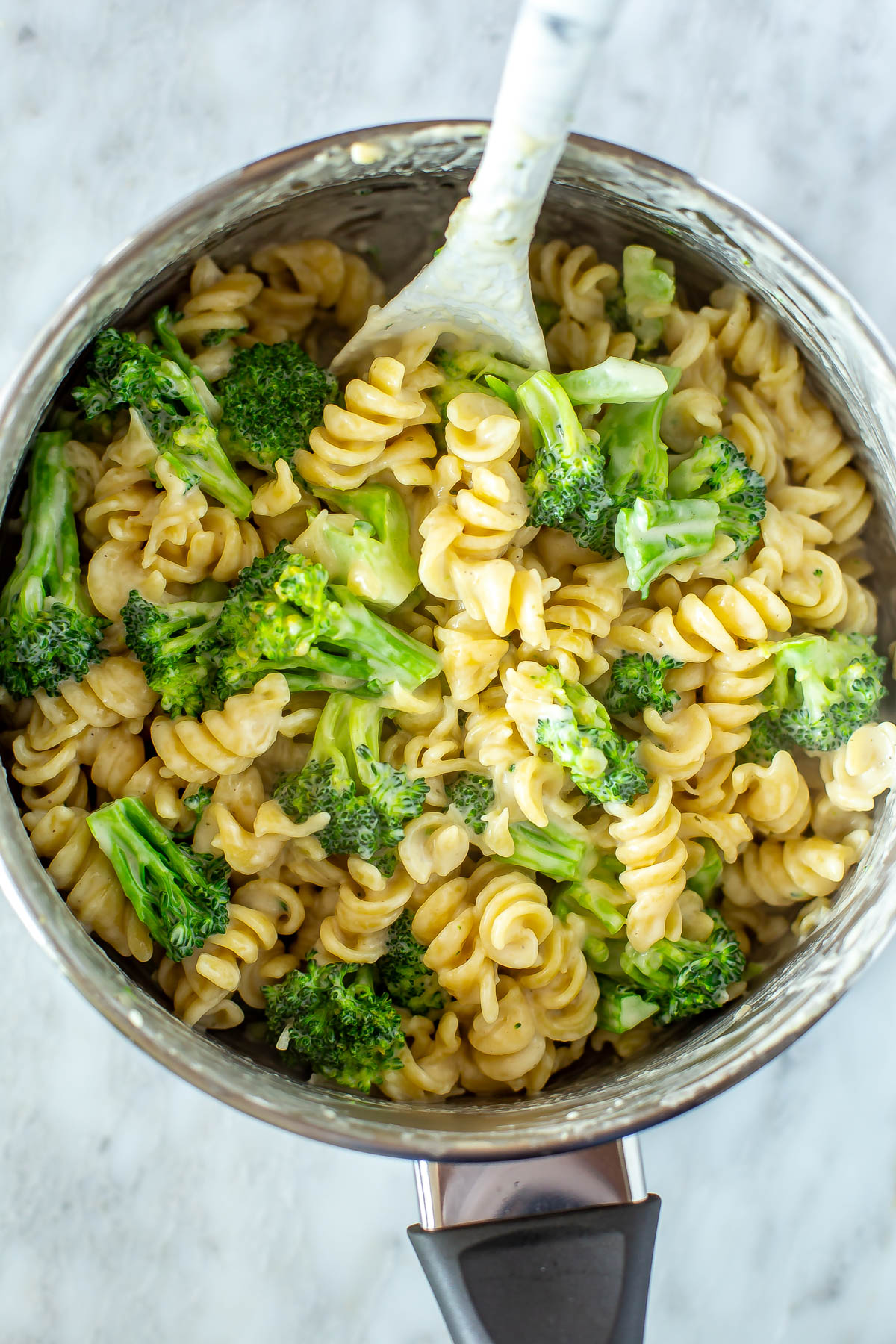 A close-up of a pot of broccoli alfredo pasta.
