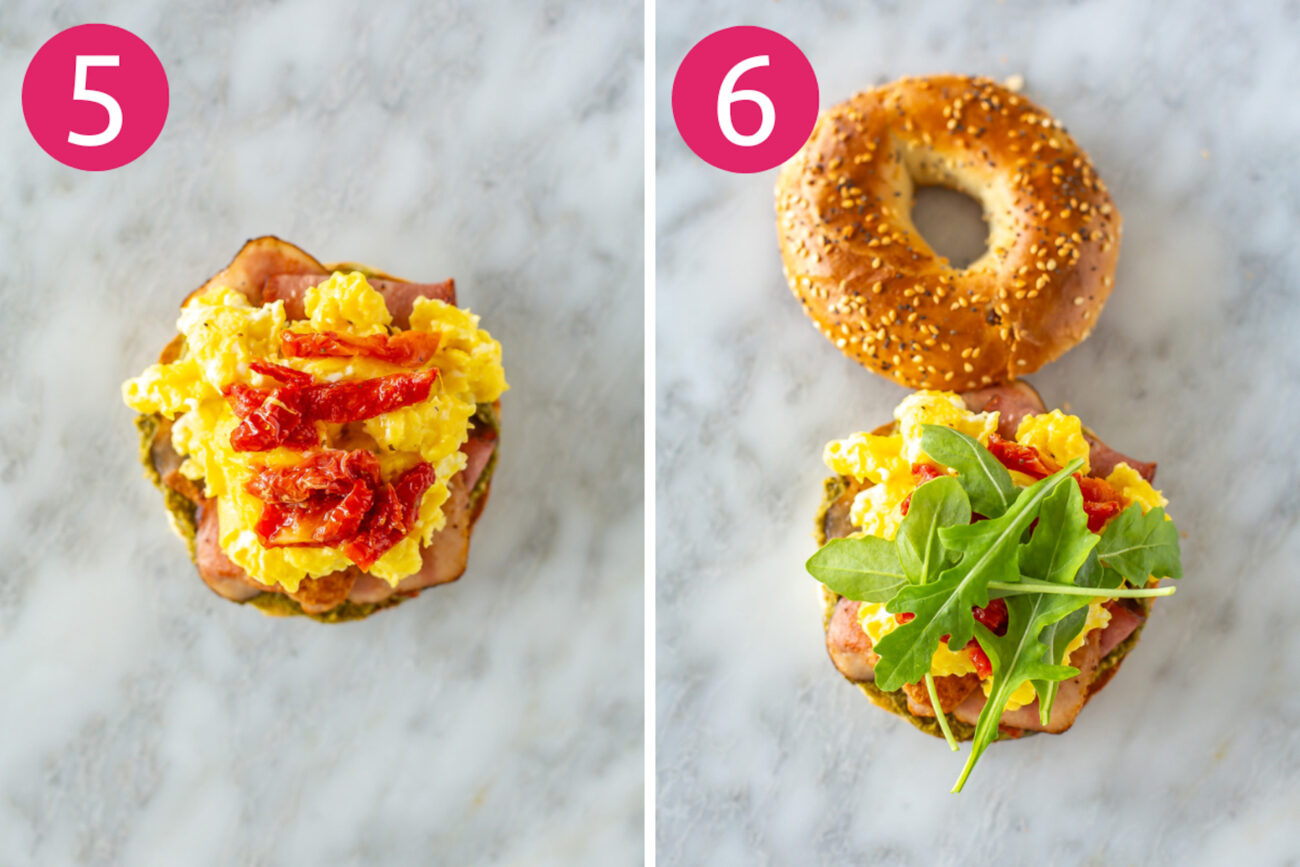 Steps 5 and 6 for making pesto bagel breakfast sandwiches: Add eggs and bacon on top, then top with sundried tomatoes and arugula.